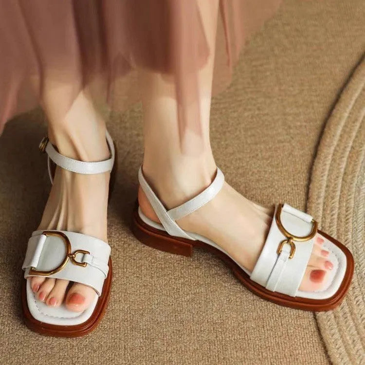 Women's brown leather sandals with a thick rubber sole and adjustable buckle strap.