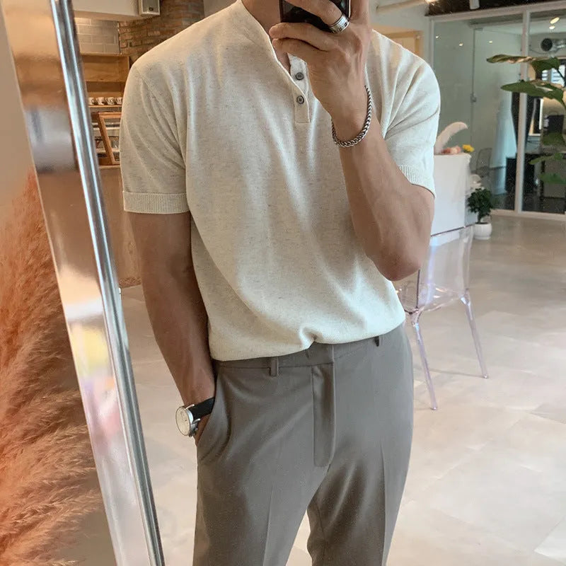Man wearing a thin black short-sleeved knitted slim-fit pullover shirt.