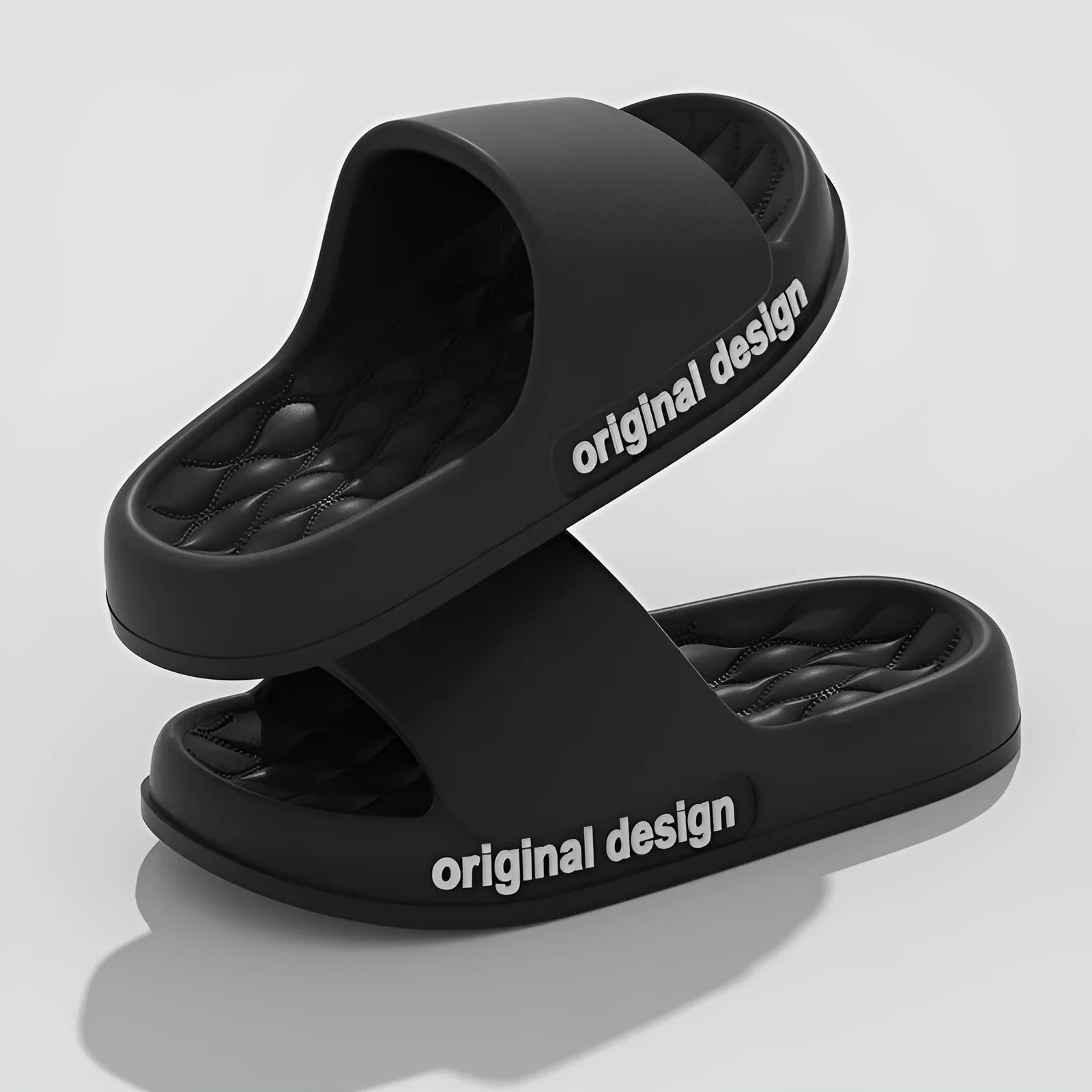 Pair of simple EVA slippers in black on a light background