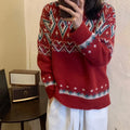 Loose red and white striped retro pullover knitted top with long sleeves on a hanger.