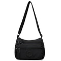 Soft water-repellent nylon crossbody bag in black with an outer pocket and zipped main compartment.