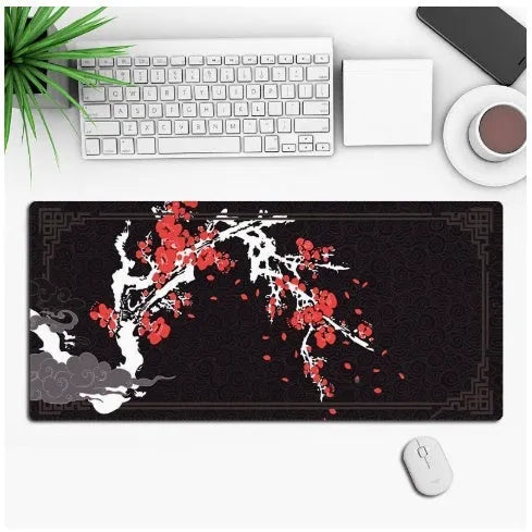 Large black anime-themed gaming mouse pad with non-slip rubber base on a wooden desk.