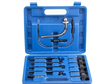 A 13-piece automatic transmission oil refuelling kit with a manual pump, hoses, and connectors laid out.