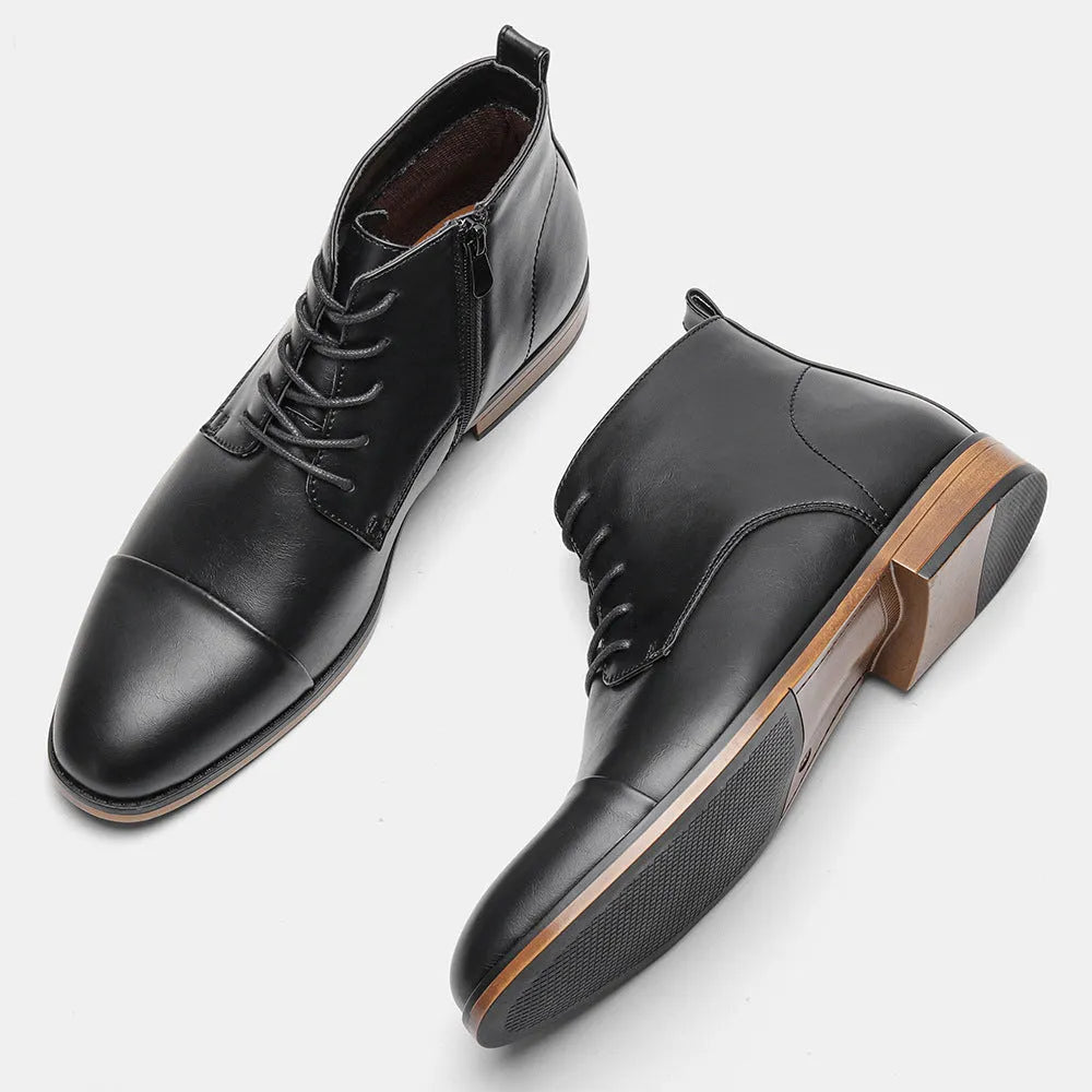 Men's brown Chelsea ankle boots with a visible side zipper on a wooden sole.