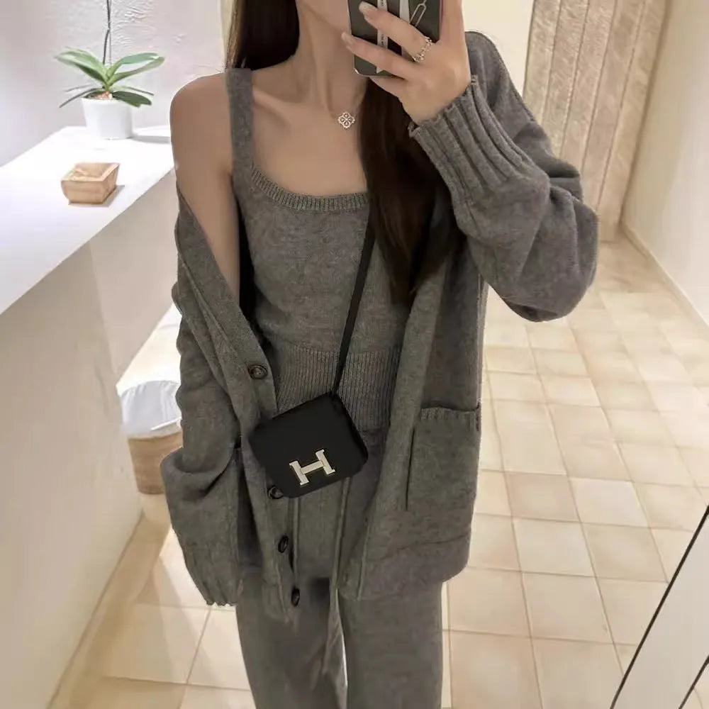 Women's light brown knit cardigan, vest, and loose trousers three-piece set laid flat.