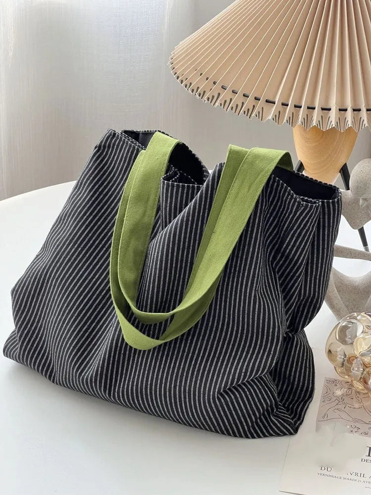 Cotton canvas multi-layer tote shoulder bag in plaid or striped pattern options with wide straps.