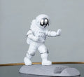 Astronaut decoration spaceman plastic mobile phone holder in blue, gold, and silver colours for lazy binge-watching