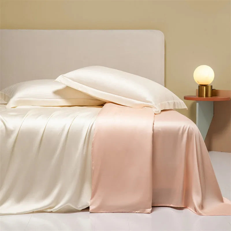Luxury Lenzing Tencel quilt cover and pillowcases in Aurora Blue on a bed, showing satin weave texture.