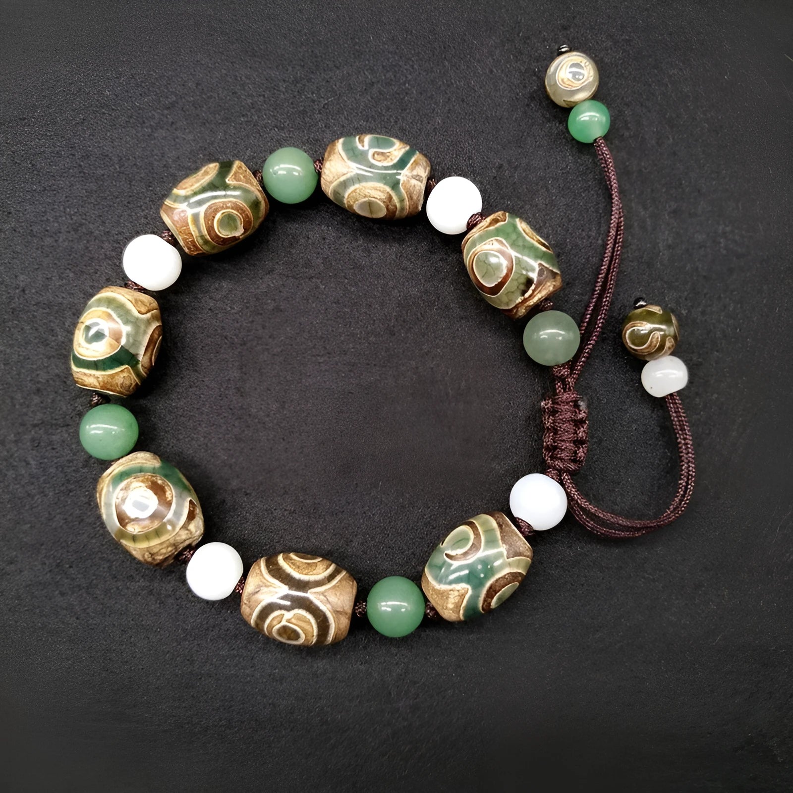Green agate Tibetan bracelet with hand-woven three-eye geometric pattern