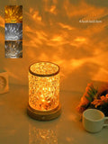 Rotating water ripple effect night light with acrylic dome on a solid wood base.