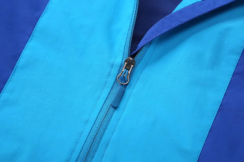 Blue thin children's autumn jacket with long sleeves and a front zip, laid flat showing size label.