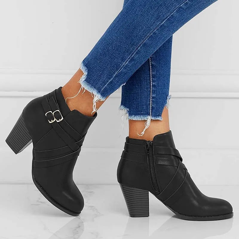 Grey plus size ankle boot with a 7cm chunky heel, side zipper, and buckle detail on a plain toe.