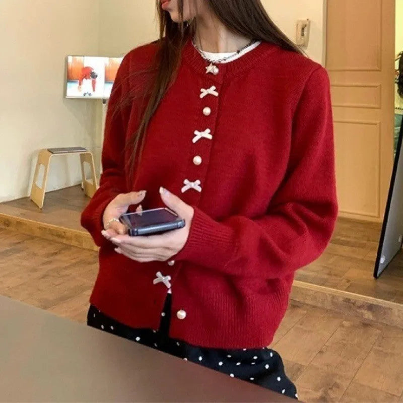 Women's acrylic cardigan with bow detail and pearl button in solid colour