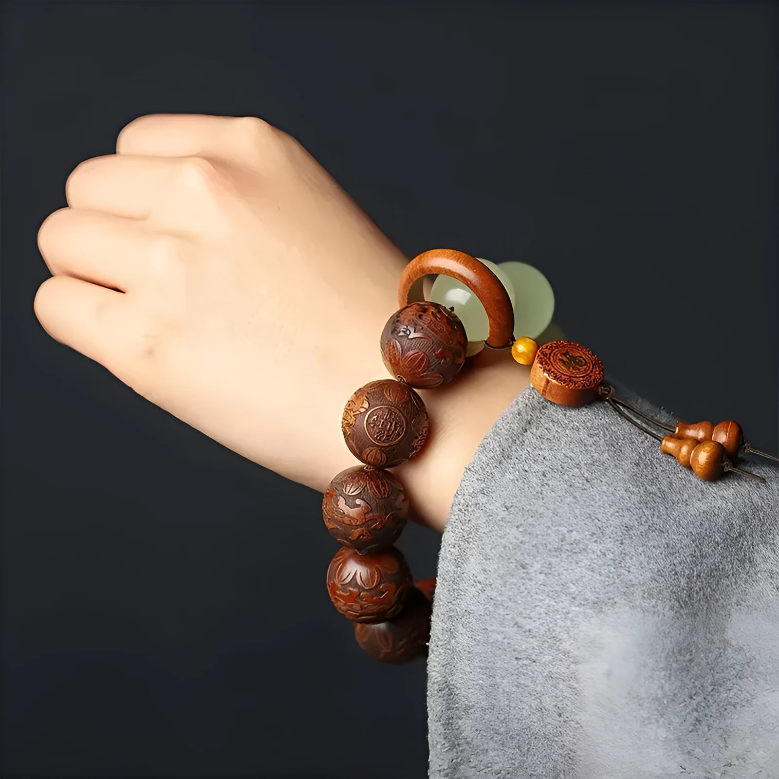 Rosewood flexible bracelet with fu character carving showing 12 wooden pieces connected by flexible cord