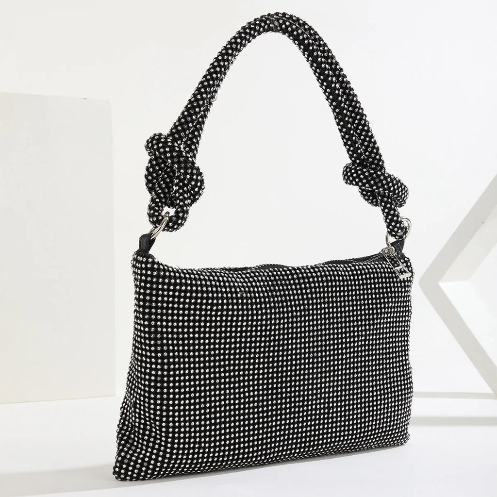 Rhinestone evening bag with full diamond finish, approximately 26x16cm, 13cm handle, polyester lining.