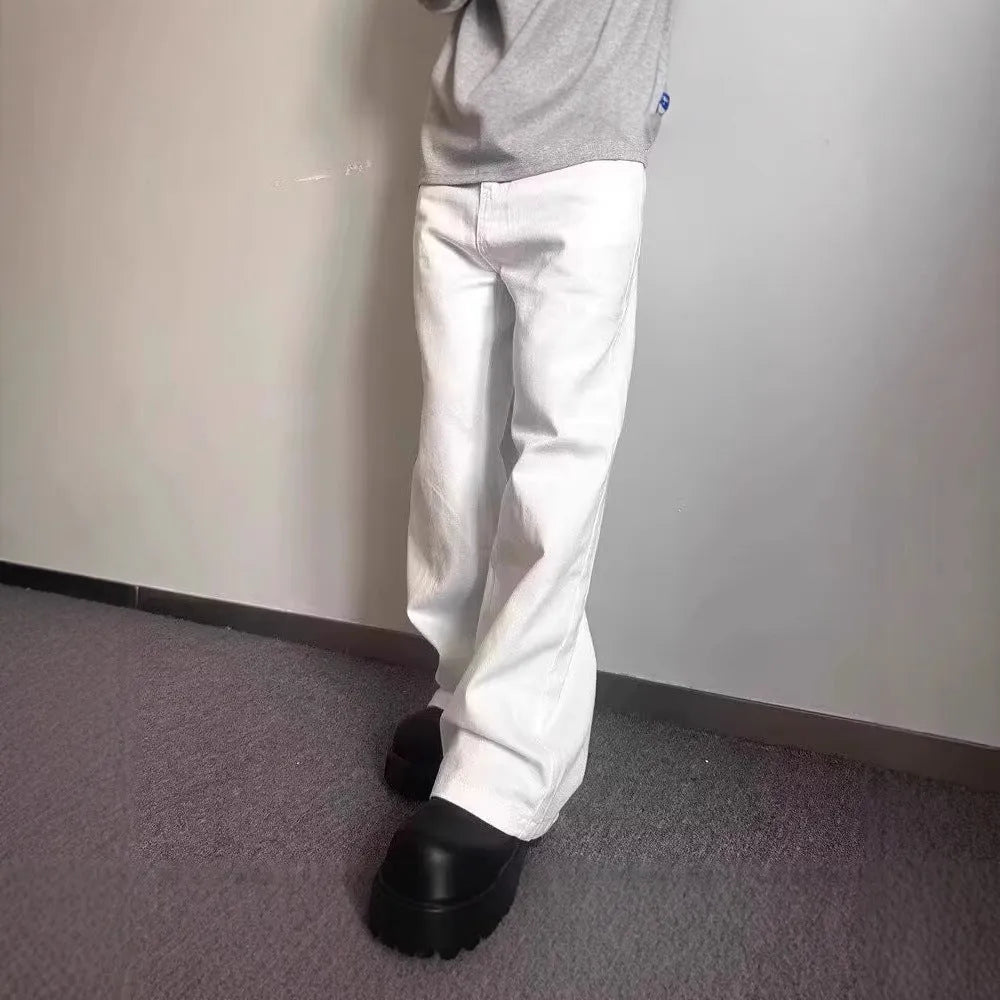 A pair of men's loose-fit white straight-leg cotton jeans on a plain background.