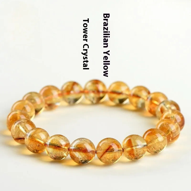 Natural yellow citrine gemstone bead bracelet on a wrist, showing geometric beads.