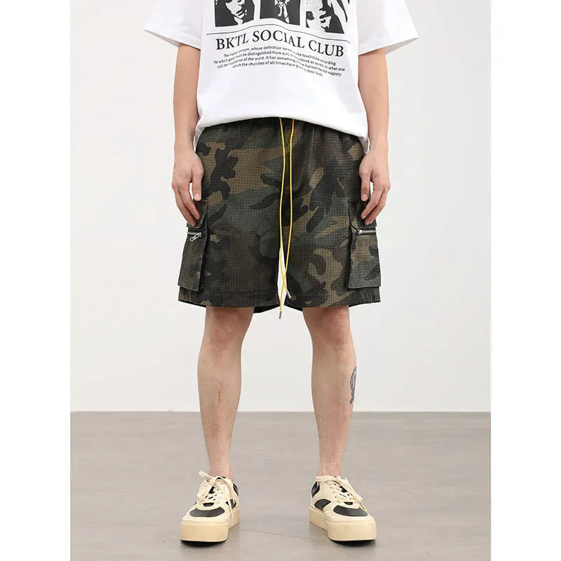 Men's camouflage work shorts with multiple pockets showing cropped length and mid-waist design