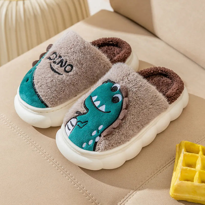 A pair of plush cotton couple slippers in a dinosaur colour theme, shown for indoor wear.