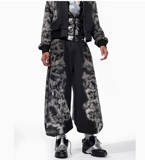 Three-piece streetwear clothing set showing printed hoodie, loose trousers, and shorts with collage stitching detail.