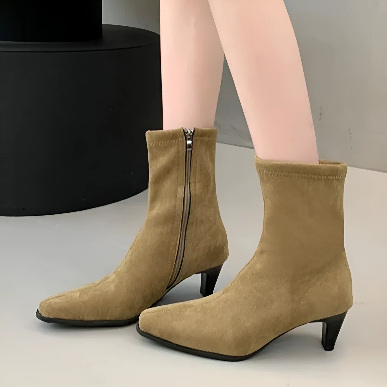 Brown square toe kitten heel mid-calf boots with side zipper on a wooden floor.