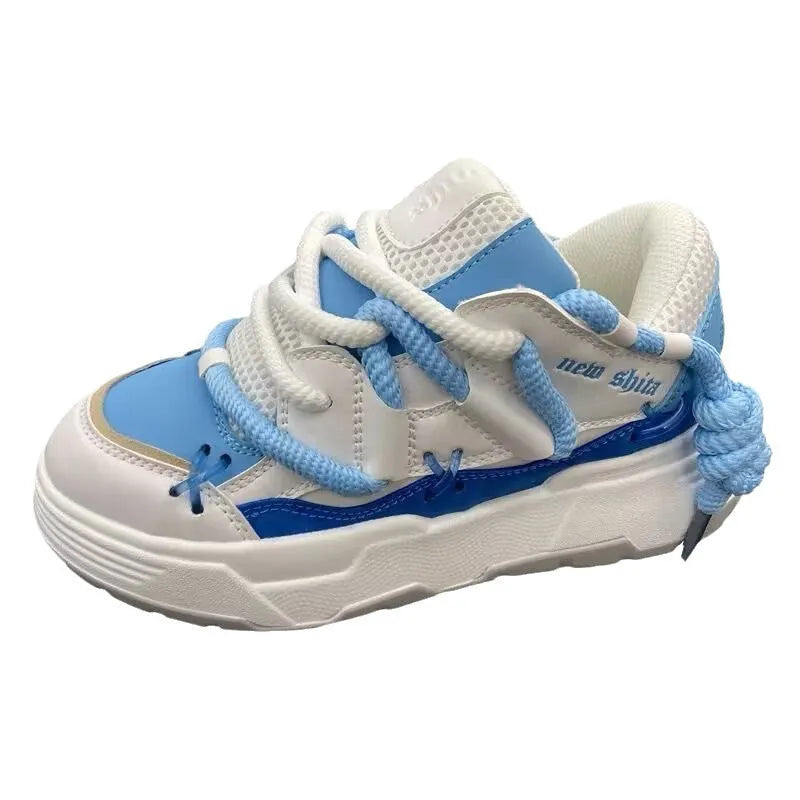Women's grey clunky platform sneakers with a thick rubber sole and lace-up front, shown on a white background.