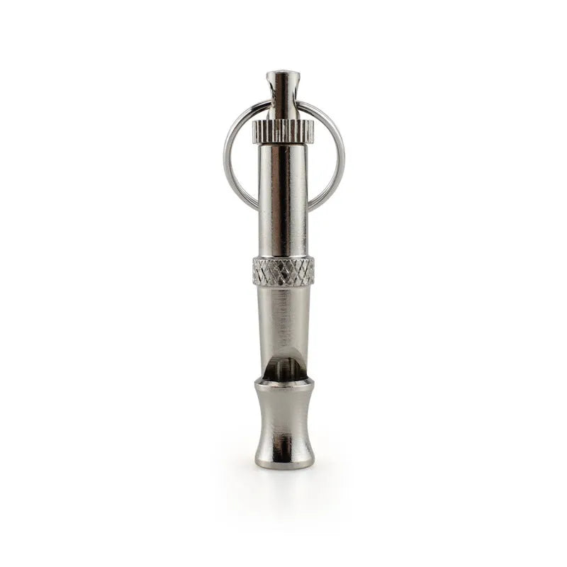Silver ultrasonic adjustable dog training whistle made from stainless steel on a light background