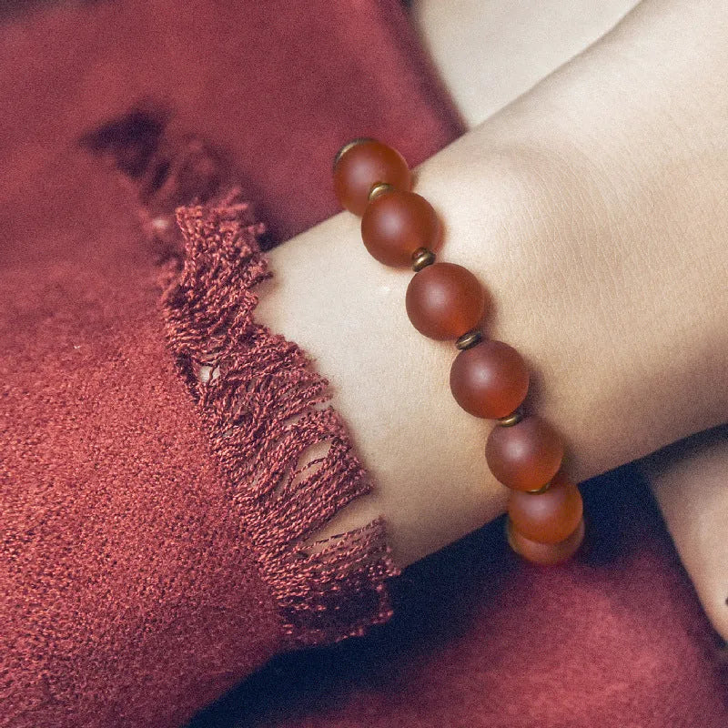 Retro ethnic style couples bracelet made of natural green and red agate beads on a string.