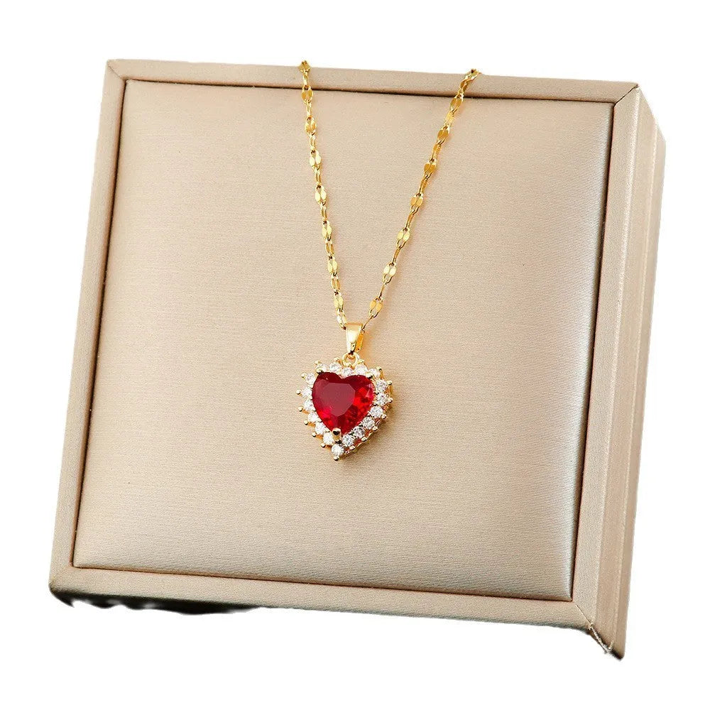 Titanium steel necklace, earrings, and ring set with heart, flower, and suit symbols in gold-red finish with gem inlay.