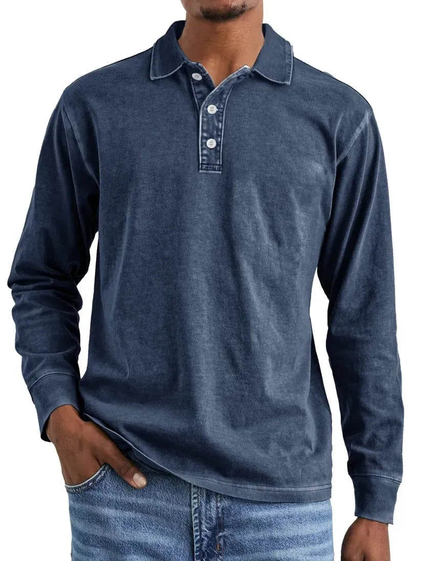 Man wearing a grey washed cotton long sleeve polo shirt with a lapel collar and subtle distressing.