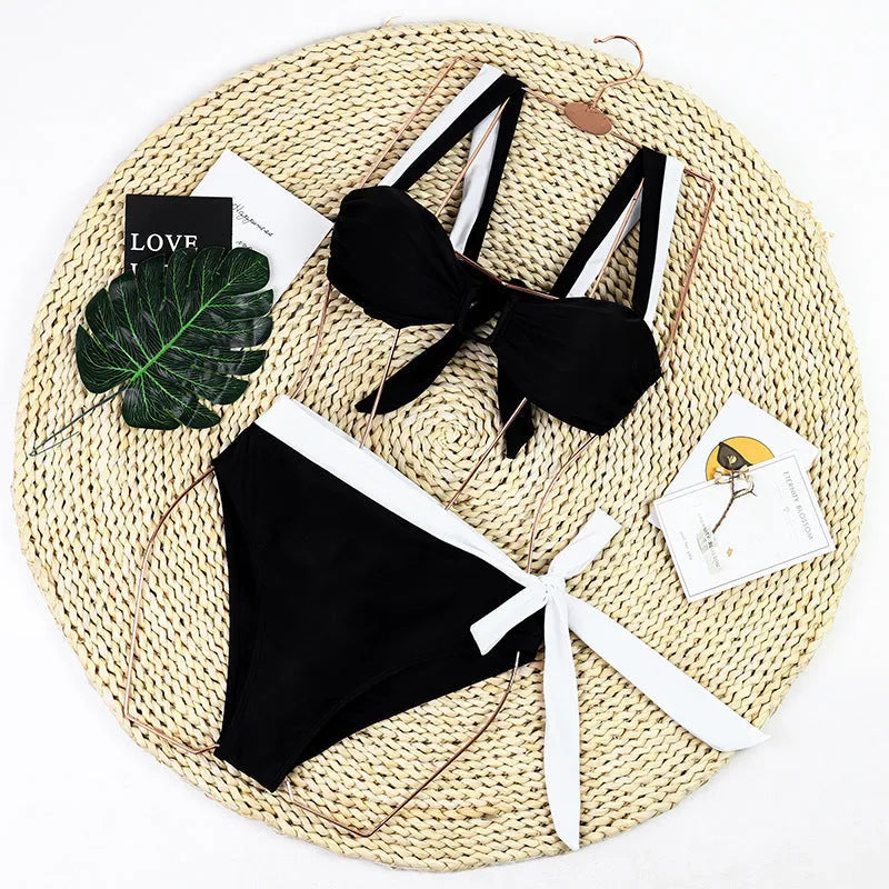 Black high-waist bikini swimsuit set on a hanger showing top and separate pants