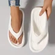 Women's black thick-soled EVA flip-flops with a non-slip sole pattern