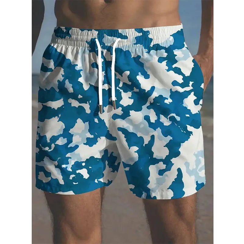 Colourful printed men's beach shorts with an elastic waistband on a neutral background.