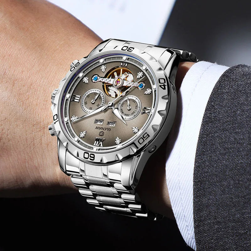 Men's automatic mechanical watch with stainless steel strap on a wrist, showing a grey dial and silver case option.