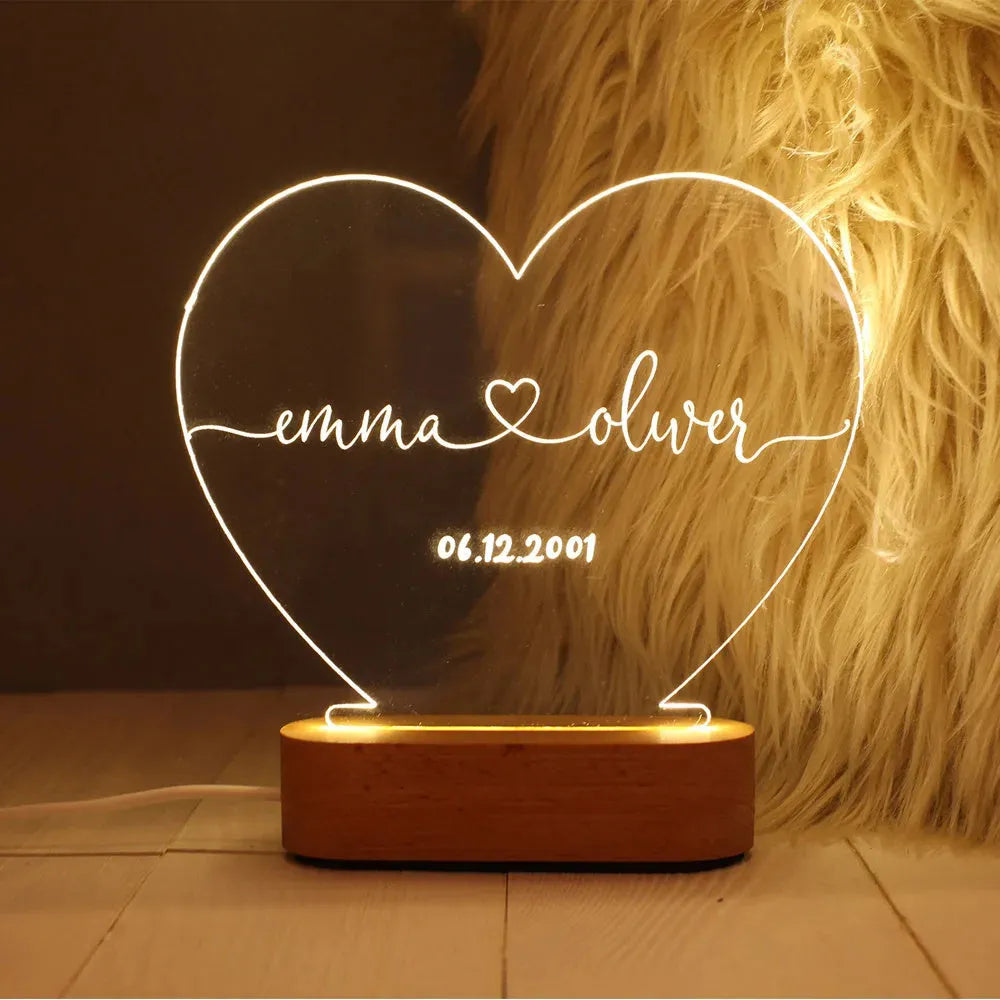Custom transparent acrylic LED night light with personalised names and date engraving.