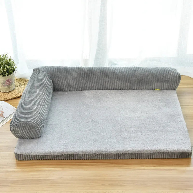 Large grey corduroy dog sofa bed with raised sides on a wooden floor