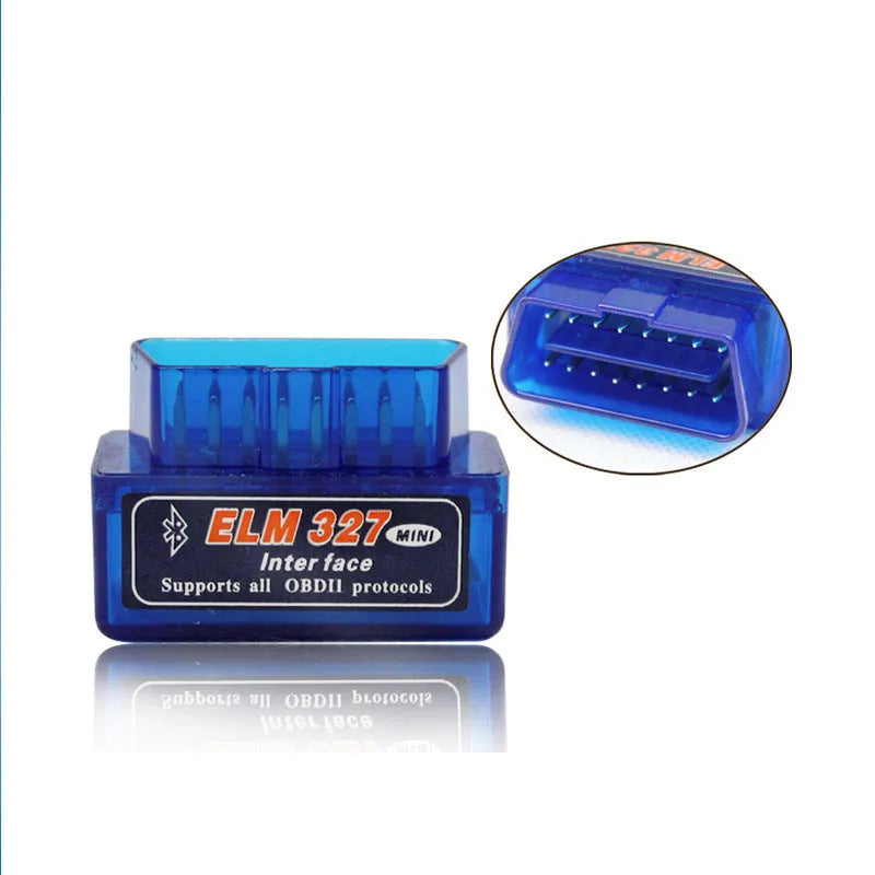 Small black ELM327 Bluetooth OBD2 diagnostic scanner plugged into a car's port.