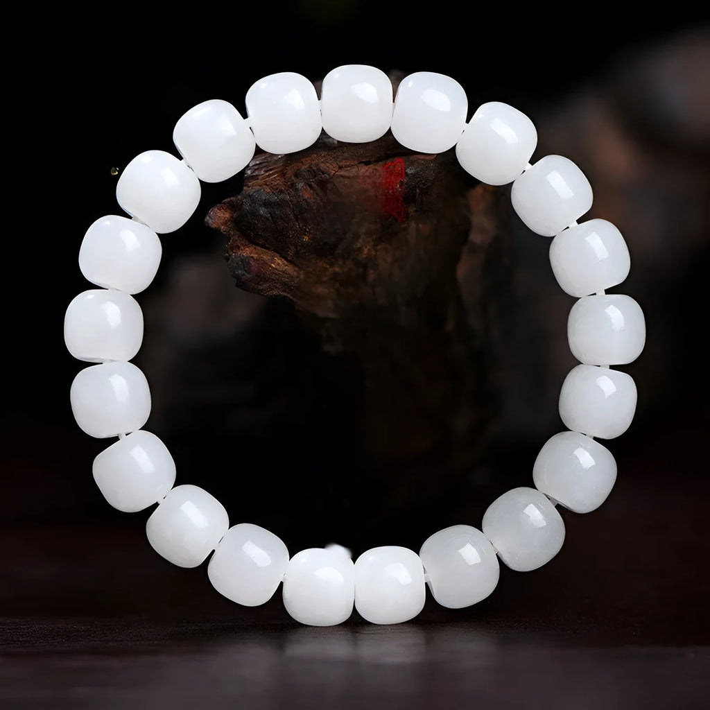 A white Hetian jade barrel bead bracelet showing three size options on a neutral background.