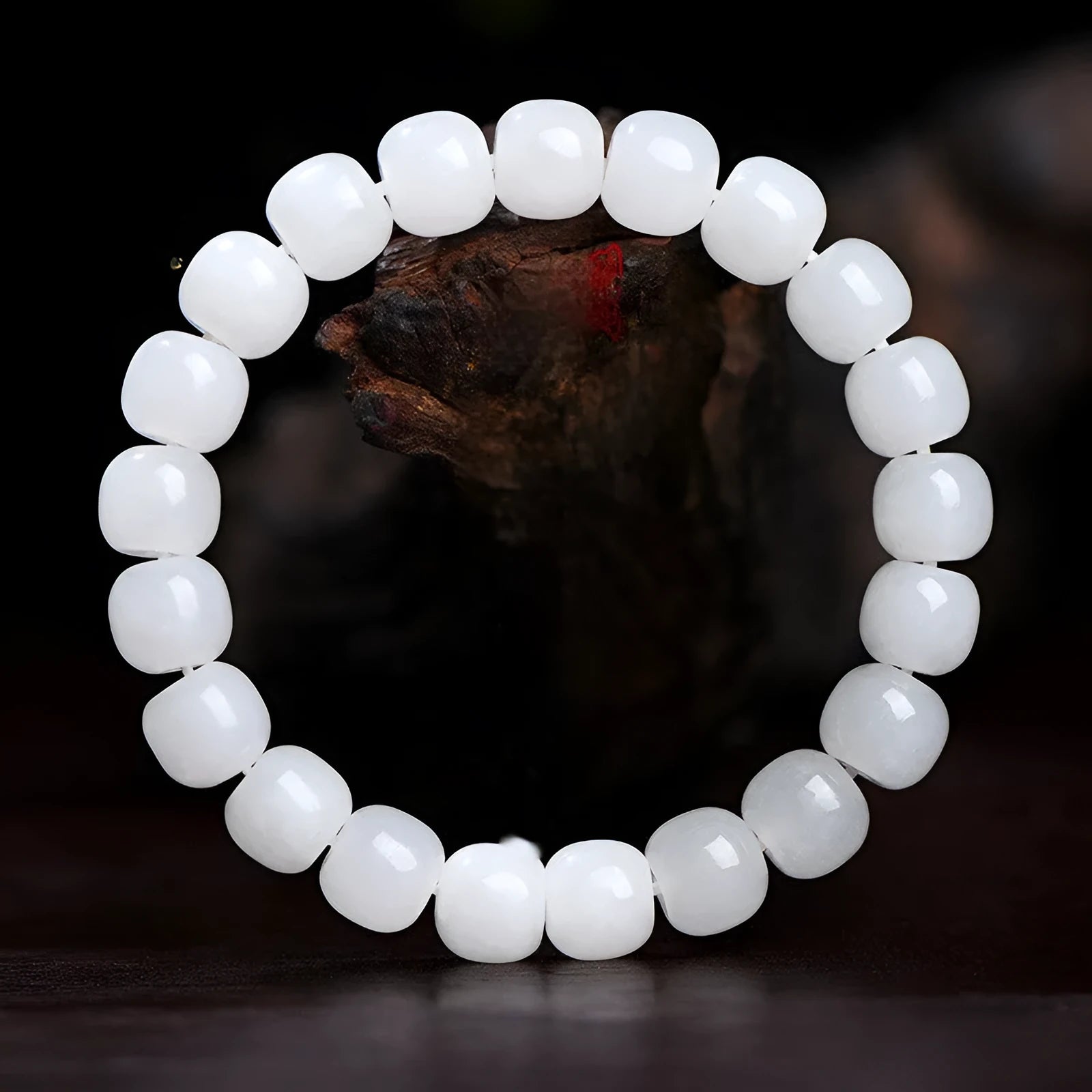 A white Hetian jade barrel bead bracelet showing three size options on a neutral background.