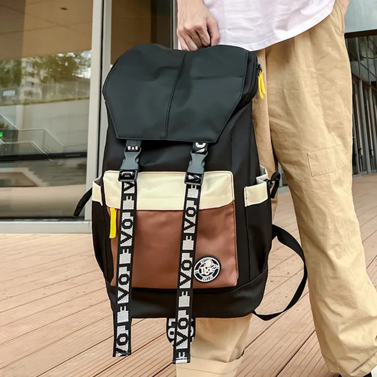 A black Oxford cloth backpack showing its size, carried over one shoulder.