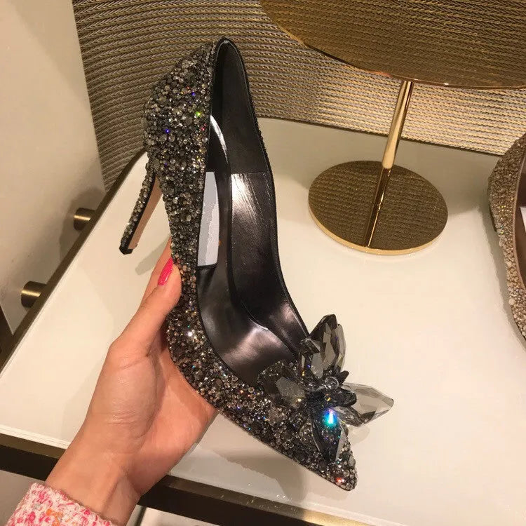 Gold women's stiletto high heels with rhinestone decoration and a pointed toe.
