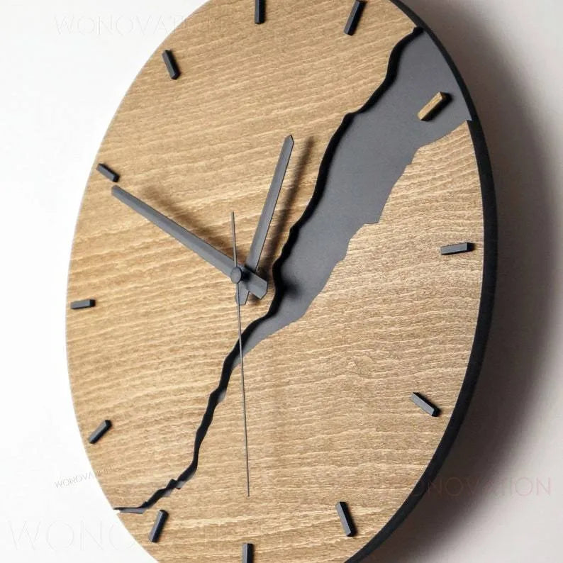 Modern wooden wall clock with creative crack design on a white wall.