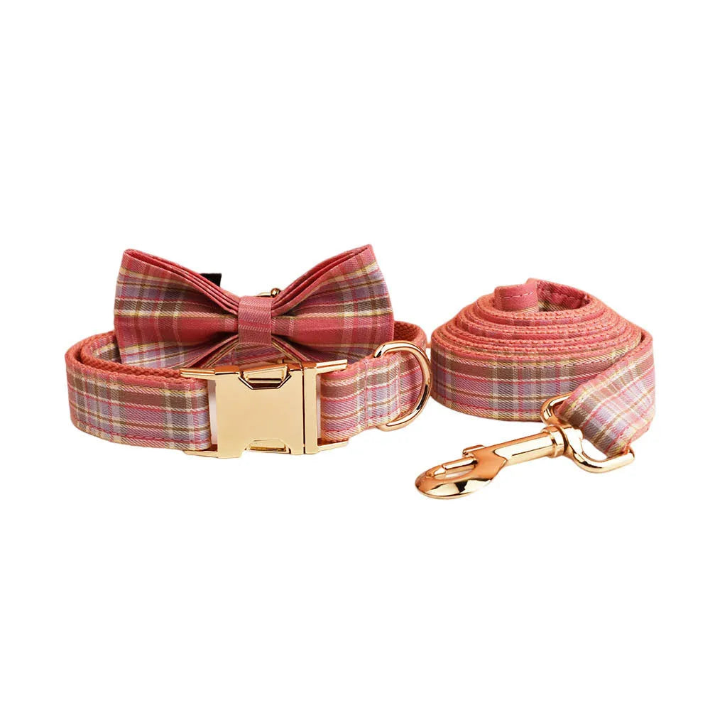 Plaid cloth dog collar and leash set with matching vest and decorative bow.