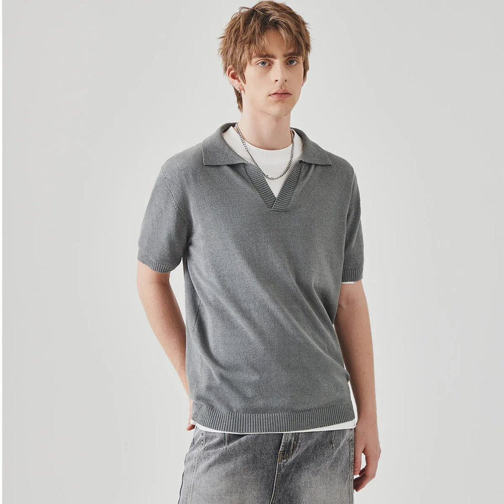 Men's solid colour knitted polo shirt with short sleeves and a collar on a hanger