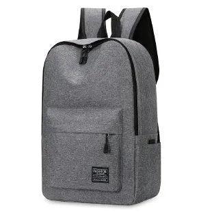 Large expandable Oxford cloth backpack in black with curved shoulder straps and front organisation.