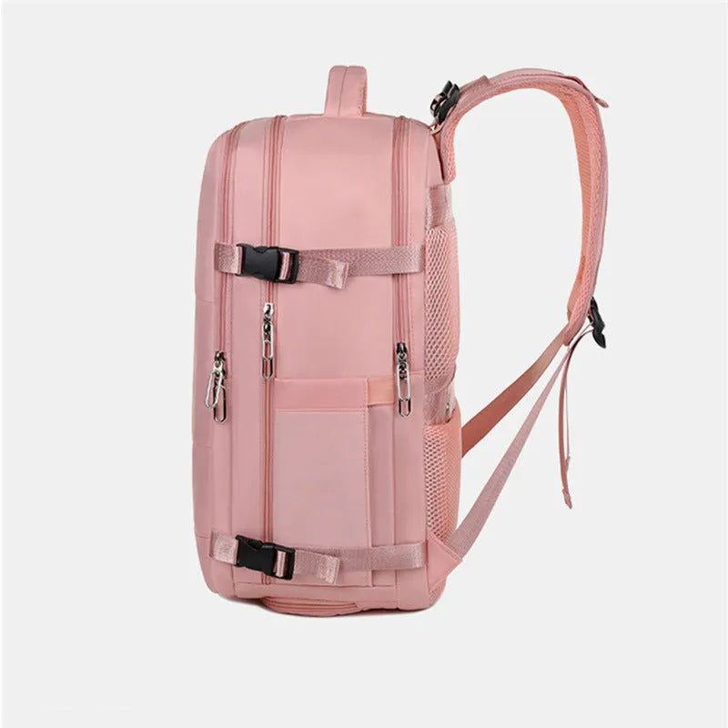Large grey travel backpack with multiple compartments and an air pillow strap, shown next to a laptop.