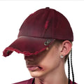 A rose red cotton peaked cap shown on a neutral background