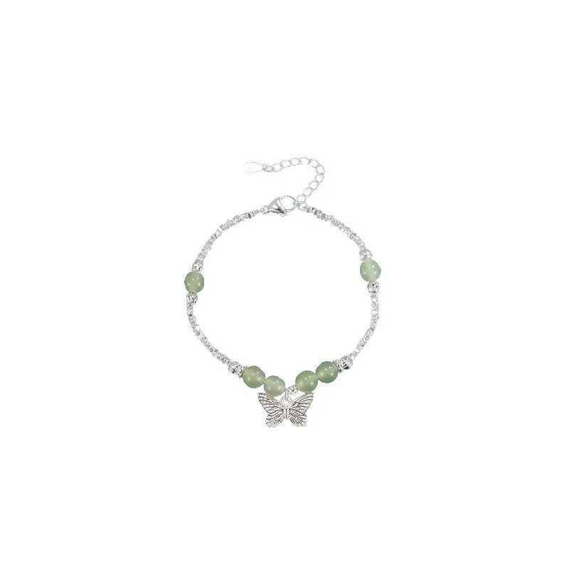 Women's copper butterfly jewellery set with electroplated silver finish, showing bracelet and necklace