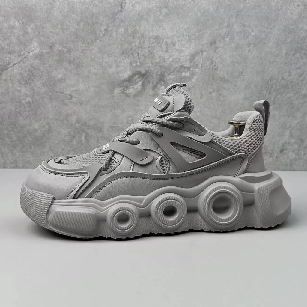 Men's low-top casual sneaker in grey with mesh upper, thick rubber sole, and round toe.