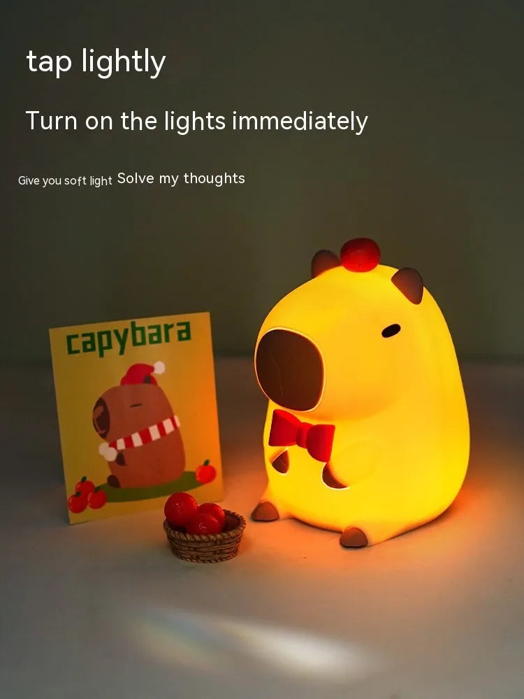 Cute capybara-shaped small night lamp on a table, showing its size and design.